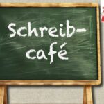 Alte grüne Schultafel mit großer weißer Kreideschrift, die das Schreib-Café ankündigt.