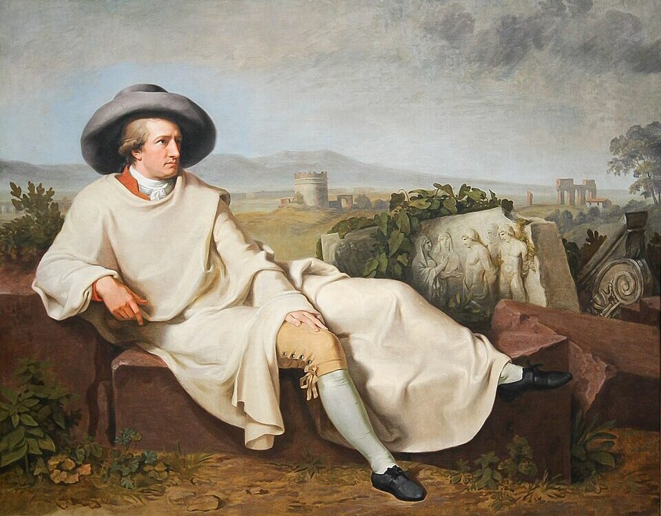Goethe in Reisekleidung sitzt entspannt in einer italienischen Landschaft.